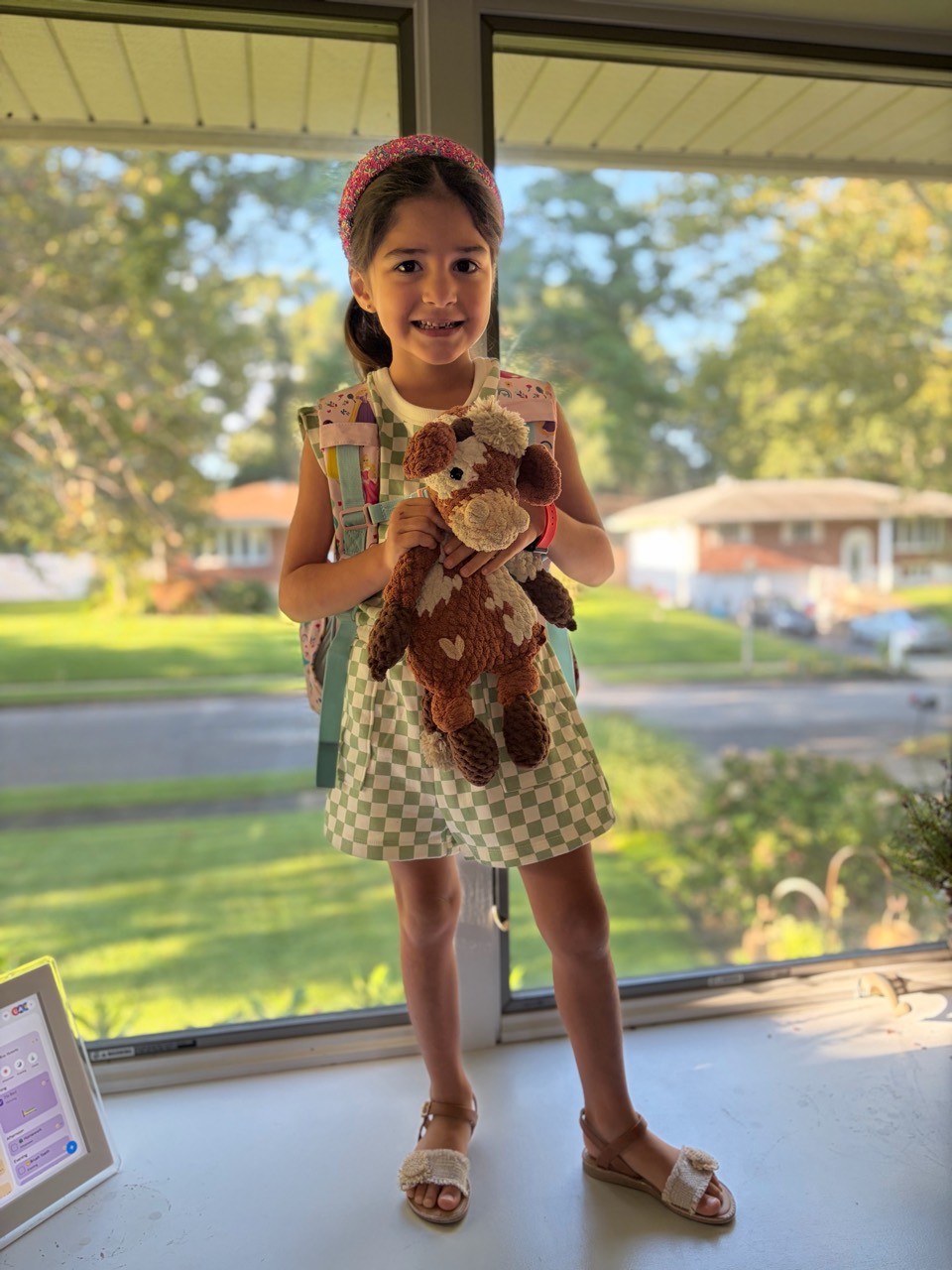 Eva holding Silly, her stuffed cow